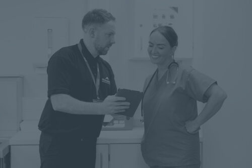 Sharpsmart employee talking to a female nurse showing information on ipad