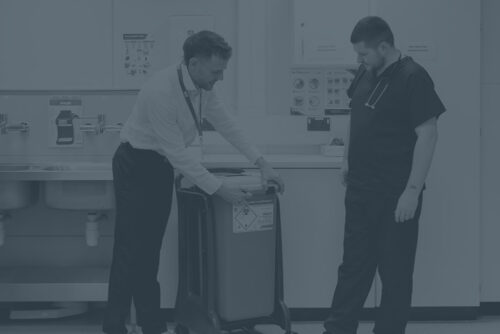 Sharpsmart employee showing nurse how to close sharpsmart container